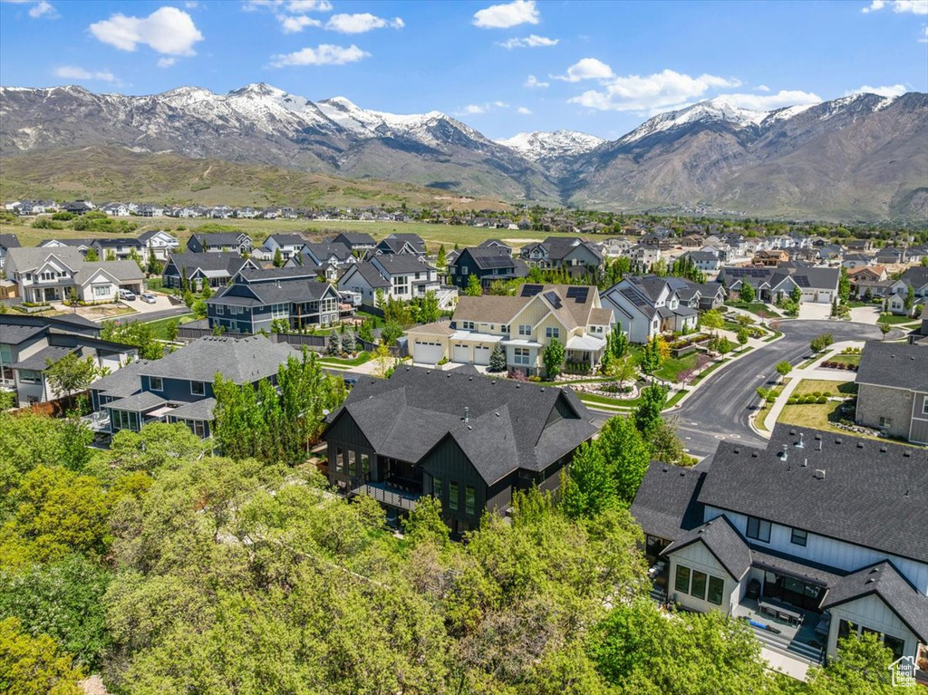 Aerial perspective of suburban area featuring a mountainous background