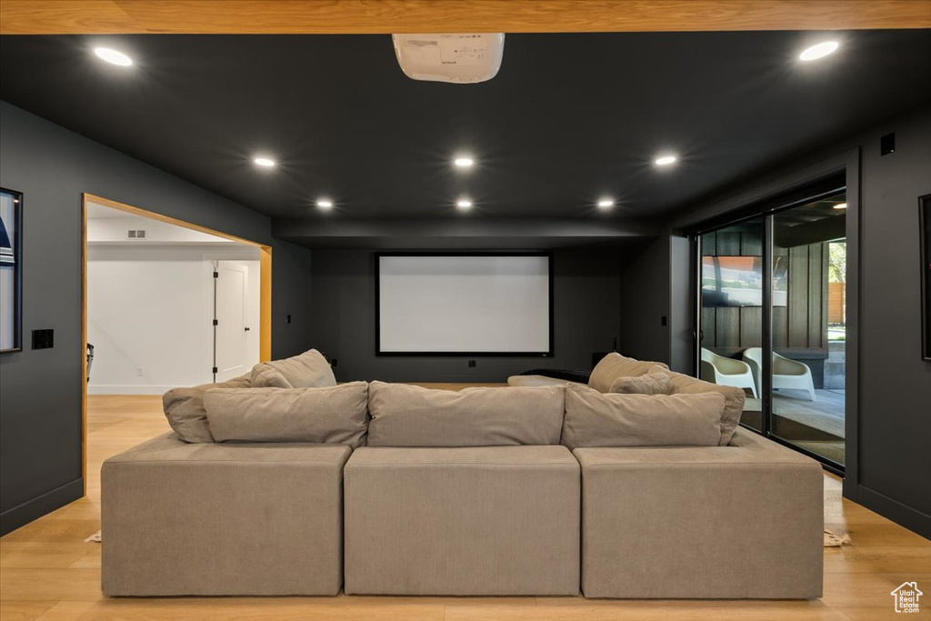Home theater featuring recessed lighting, light wood-style flooring, and baseboards