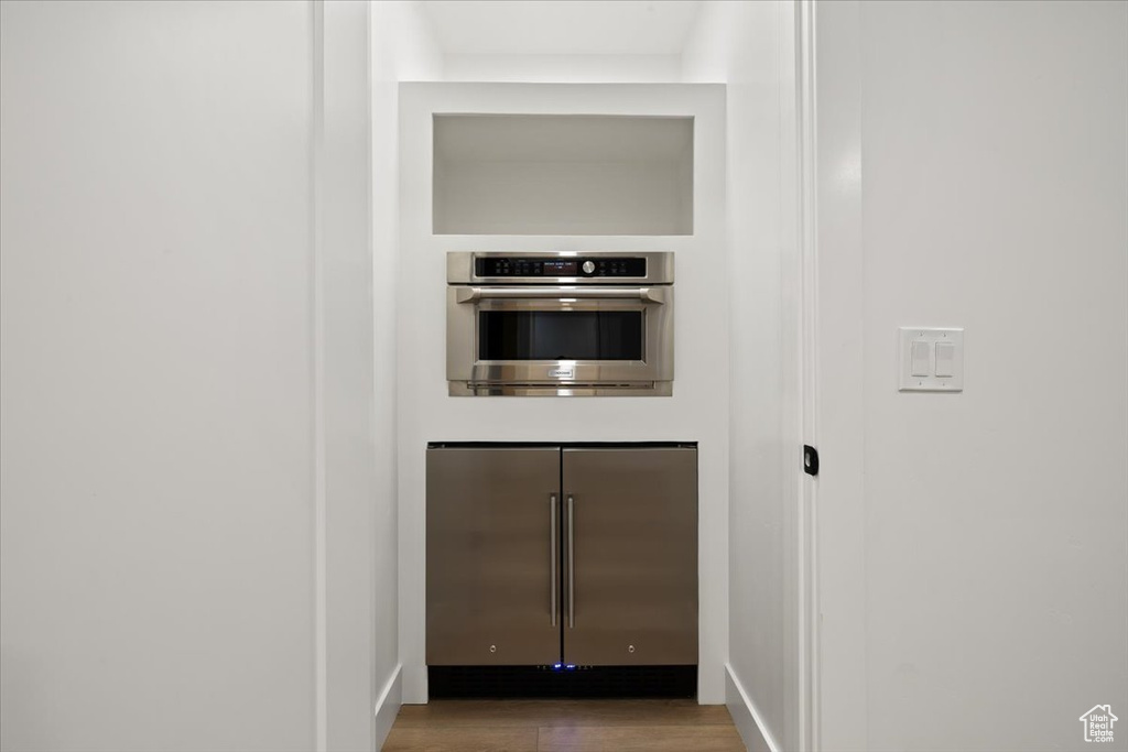 Entryway with wood finished floors and baseboards
