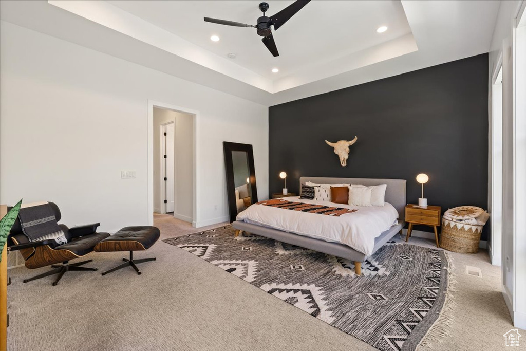 Bedroom with carpet flooring, recessed lighting, an accent wall, ceiling fan, and a raised ceiling