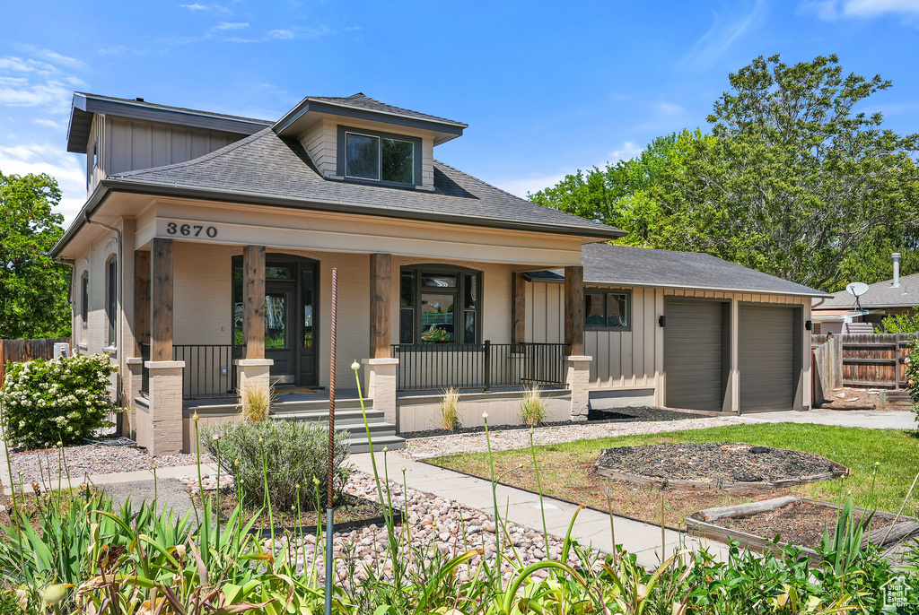 Bungalow-style home with covered porch, board and batten siding, a shingled roof, and a garage