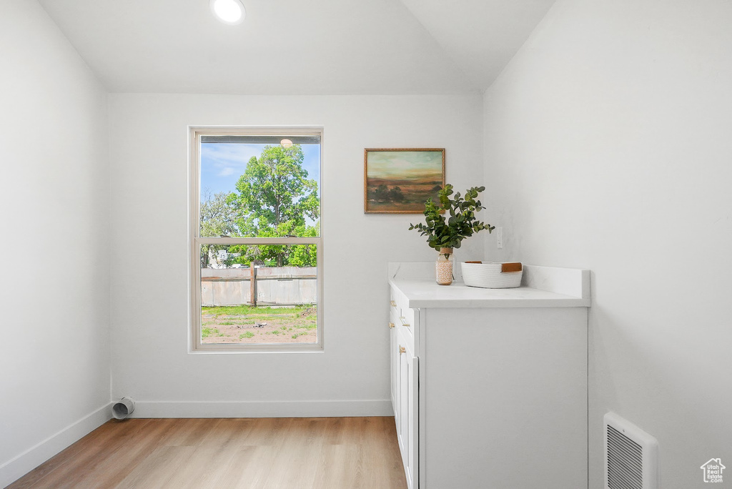 Entryway with light wood-style floors and baseboards