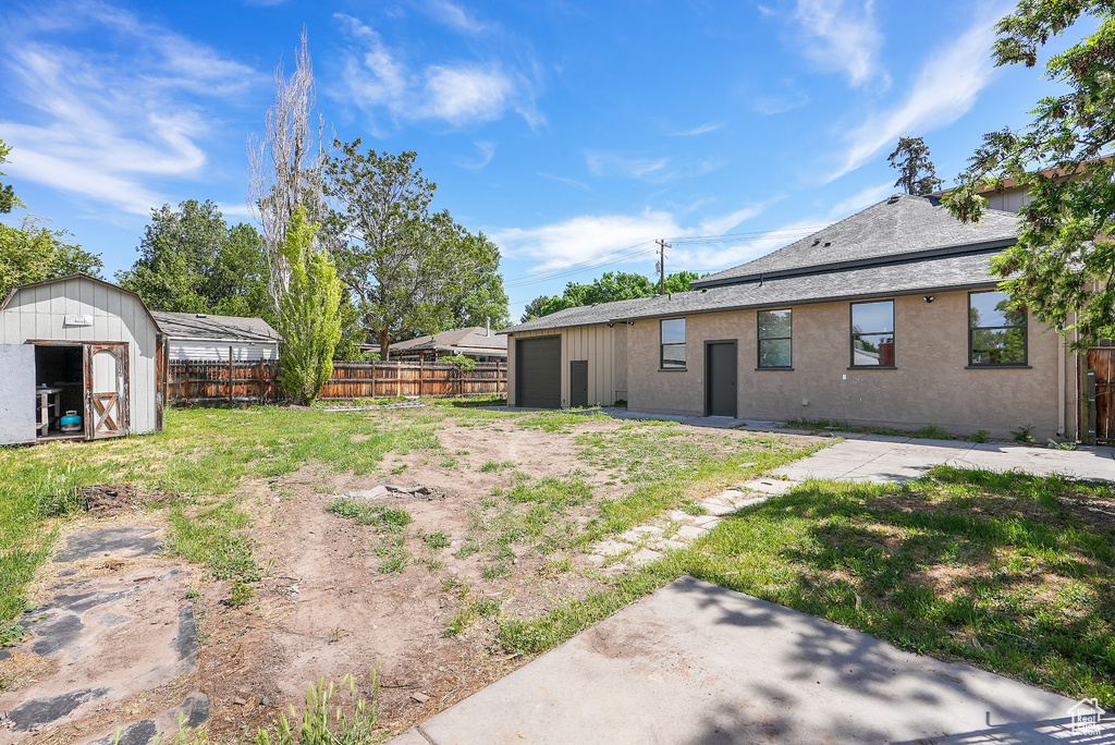 View of yard featuring a storage unit and an outbuilding
