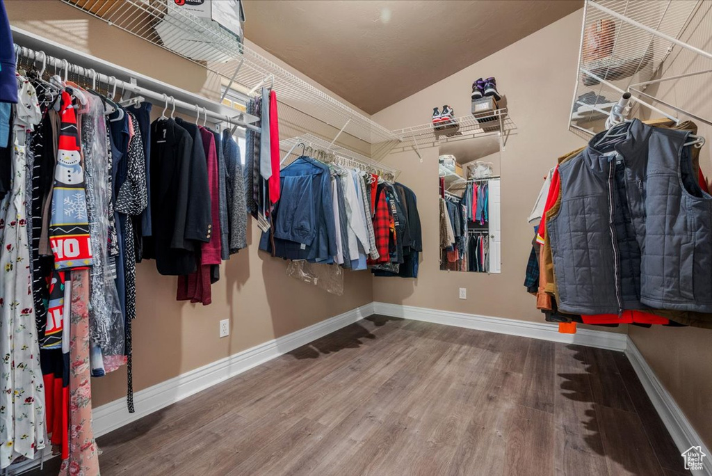 Spacious closet featuring wood finished floors and lofted ceiling