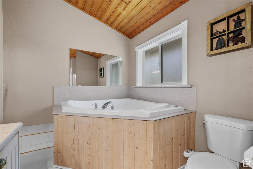 Full bathroom featuring wooden ceiling, toilet, vaulted ceiling, and a garden tub