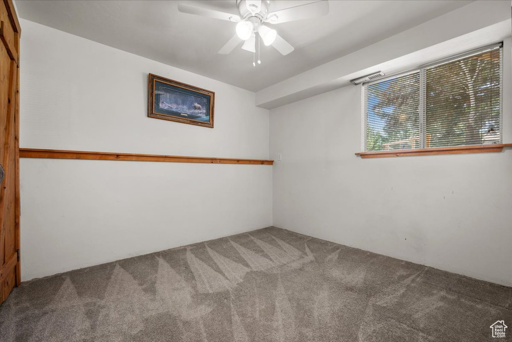 Unfurnished room featuring carpet flooring and ceiling fan