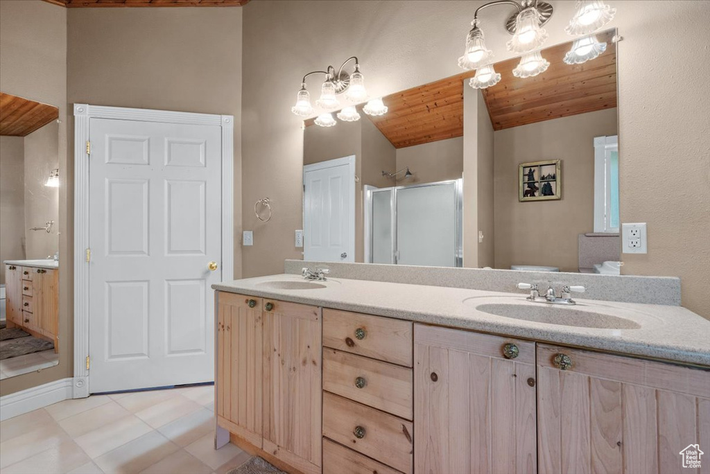 Full bath featuring wooden ceiling, a shower stall, double vanity, and tile patterned floors