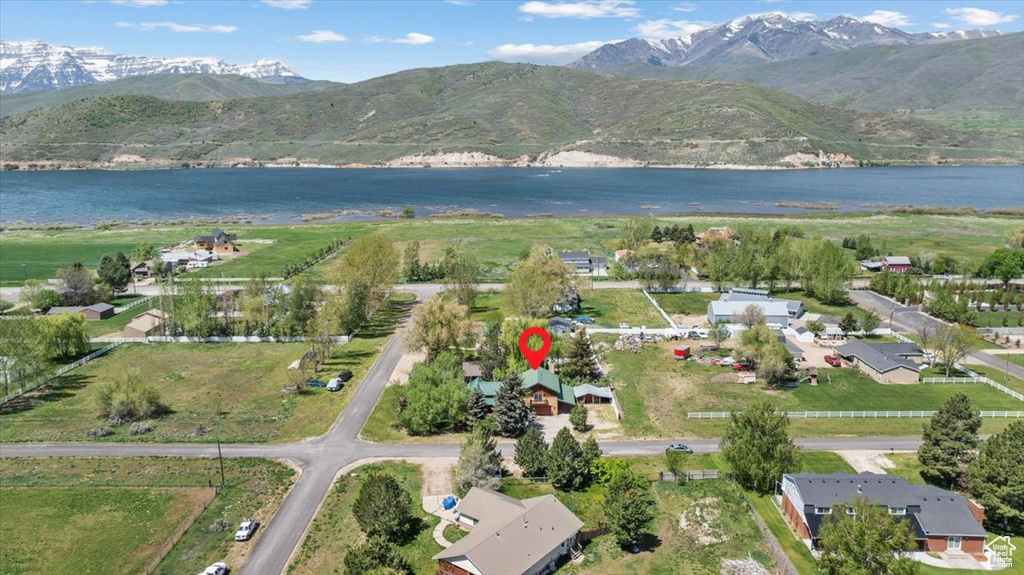 Aerial view of property's location featuring a water and mountain view