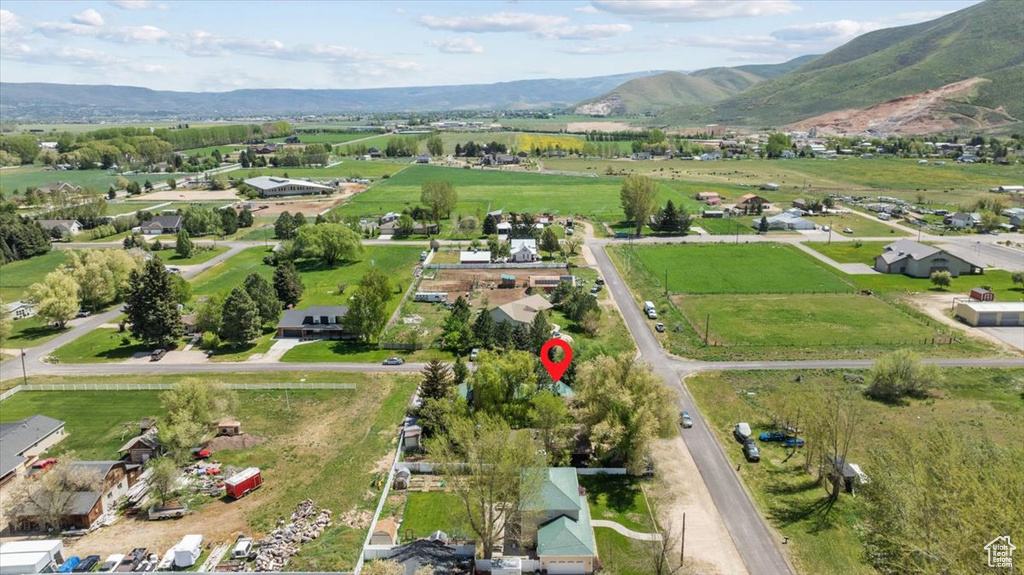 Aerial overview of property's location featuring a mountain backdrop and rural landscape