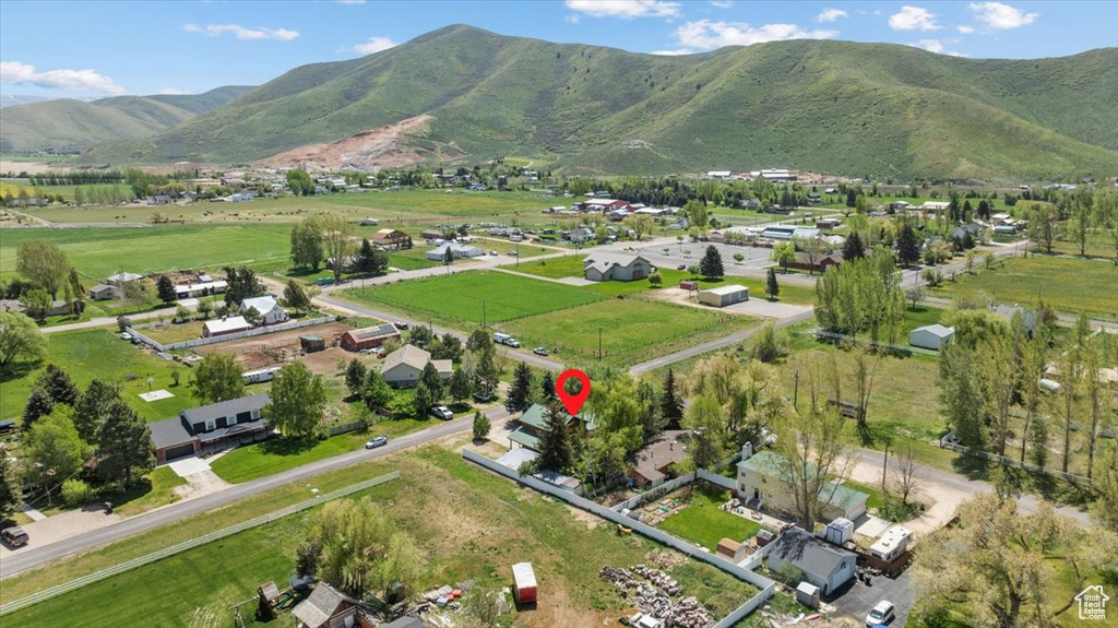 Aerial view of property and surrounding area with a mountainous background