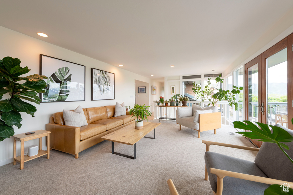 Living room featuring light colored carpet, recessed lighting, and french doors