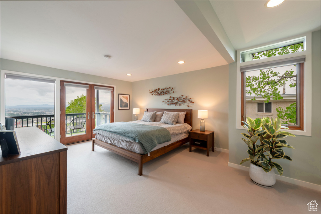 Bedroom featuring access to outside, light carpet, baseboards, and recessed lighting