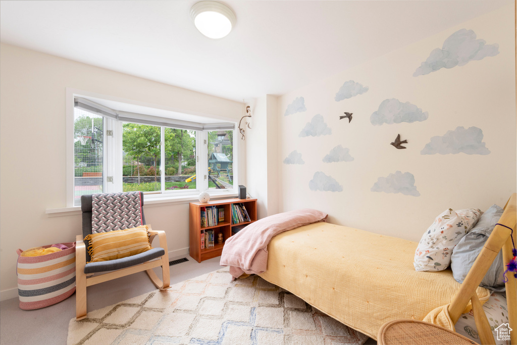 Carpeted bedroom featuring baseboards