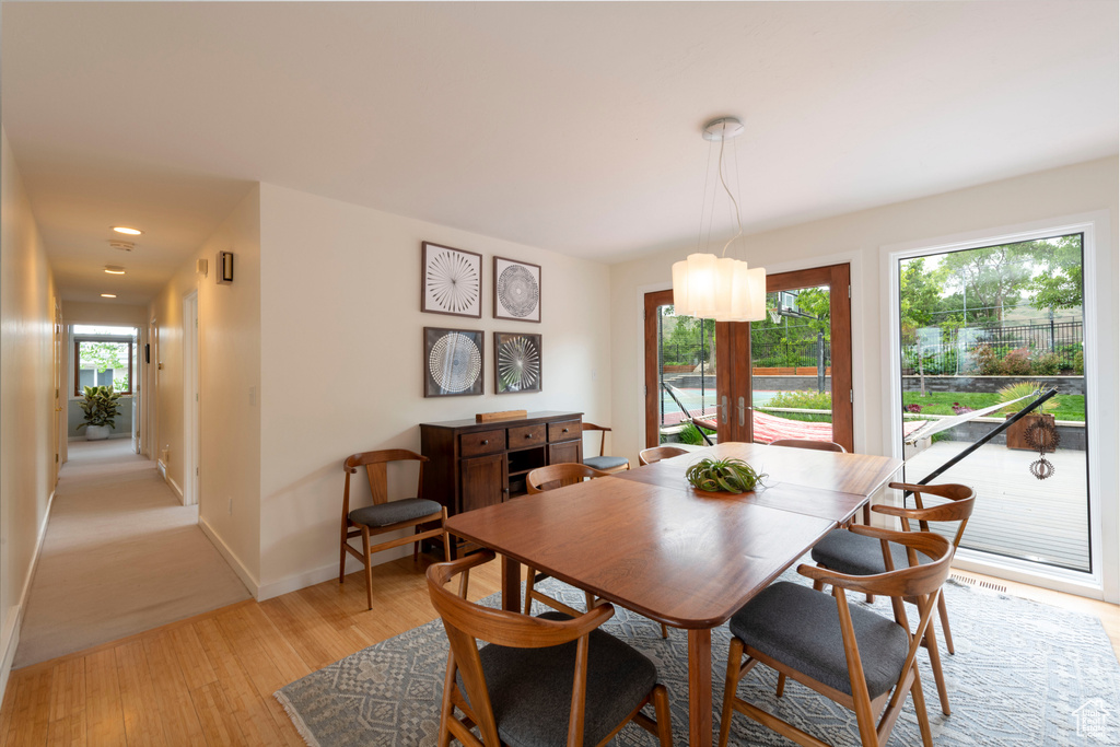 Dining area featuring baseboards, light wood-style flooring, and recessed lighting