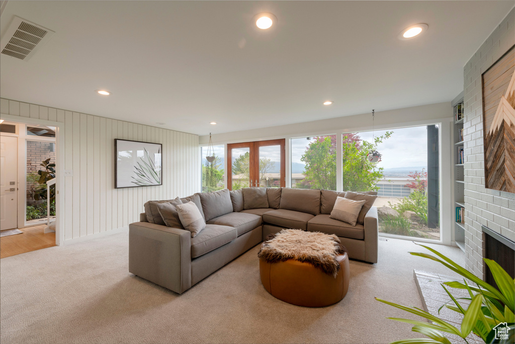 Living area with carpet floors, a fireplace, and recessed lighting
