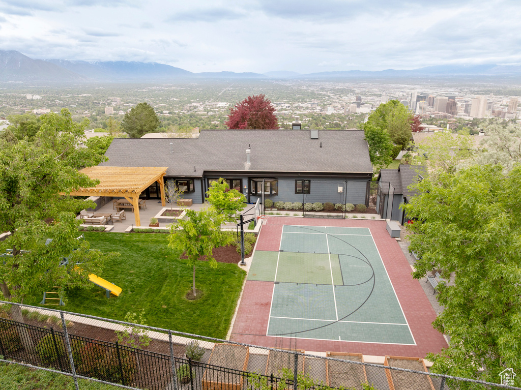 View of basketball court featuring a mountain view and community basketball court