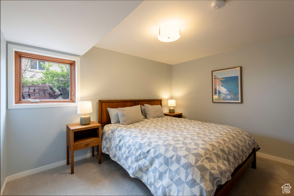 Bedroom featuring carpet floors and baseboards