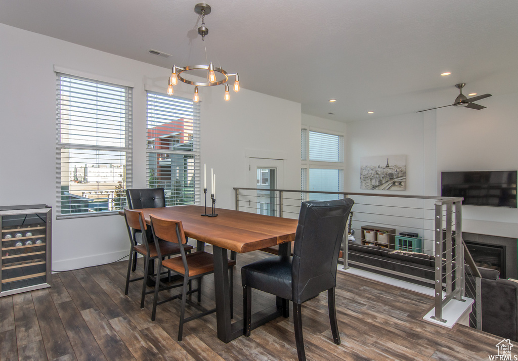 Dining space featuring wine cooler, wood finished floors, baseboards, recessed lighting, and a ceiling fan