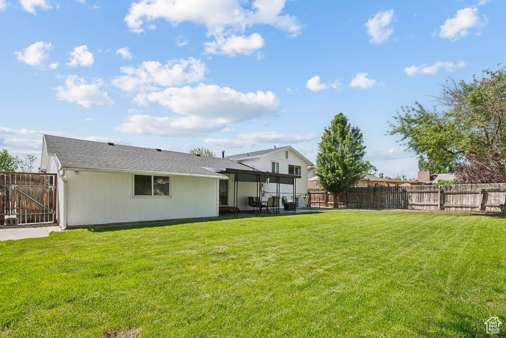 View of yard featuring a patio area and a gate