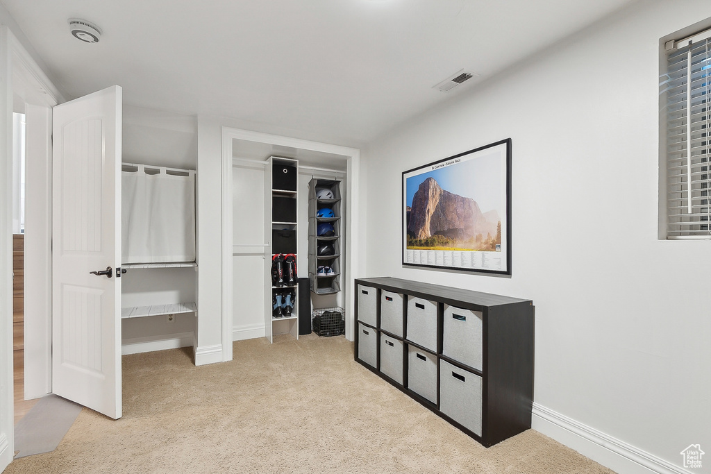Bedroom featuring carpet and baseboards