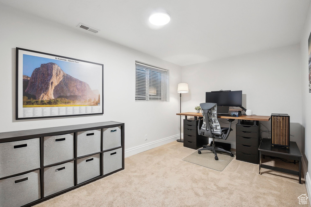 Home office with carpet floors and baseboards