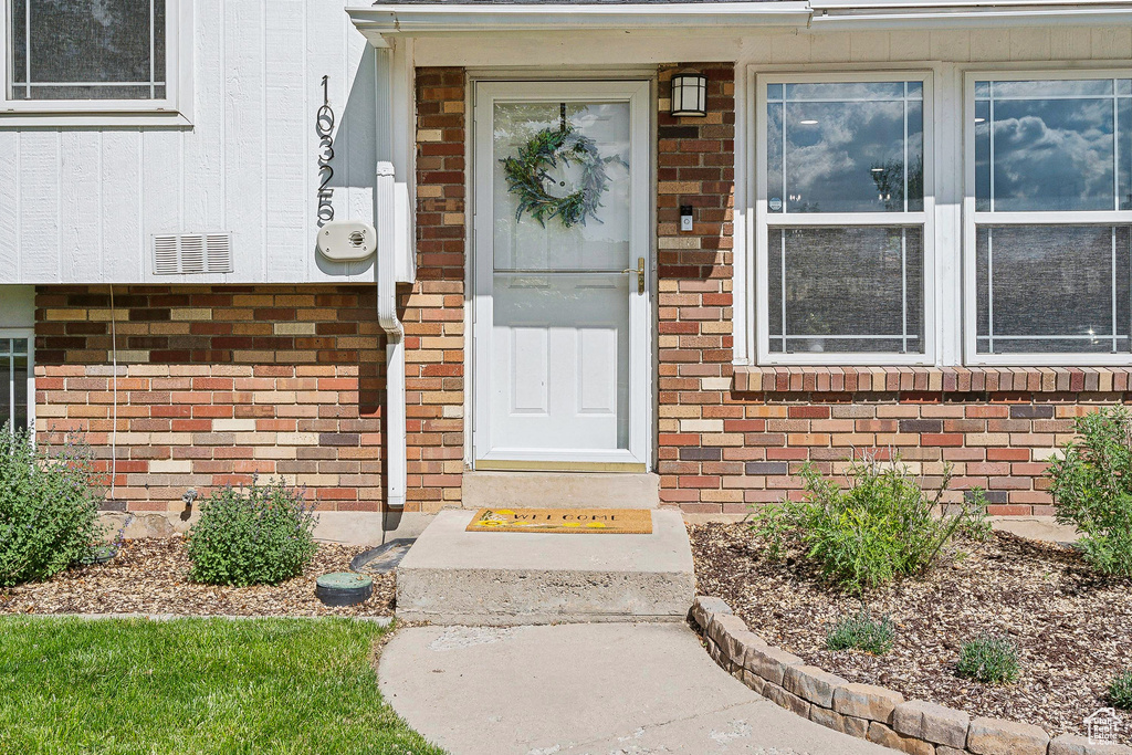 Property entrance featuring brick siding