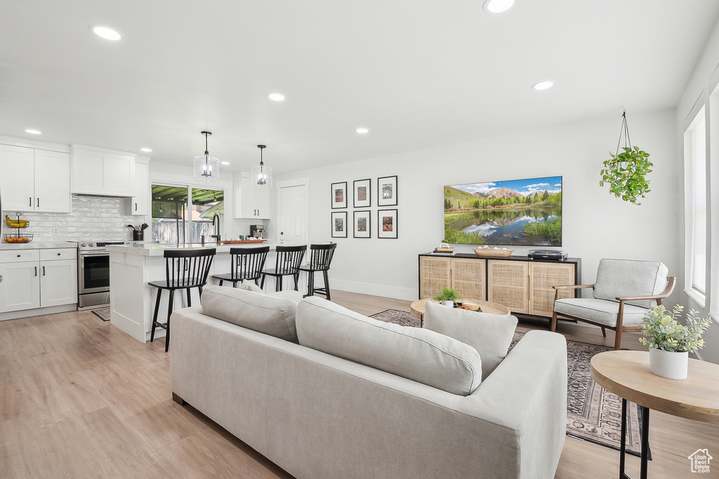 Living area featuring recessed lighting, light wood-type flooring, and baseboards