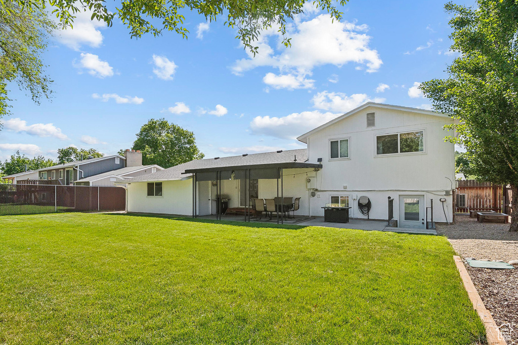 Rear view of property with a patio area