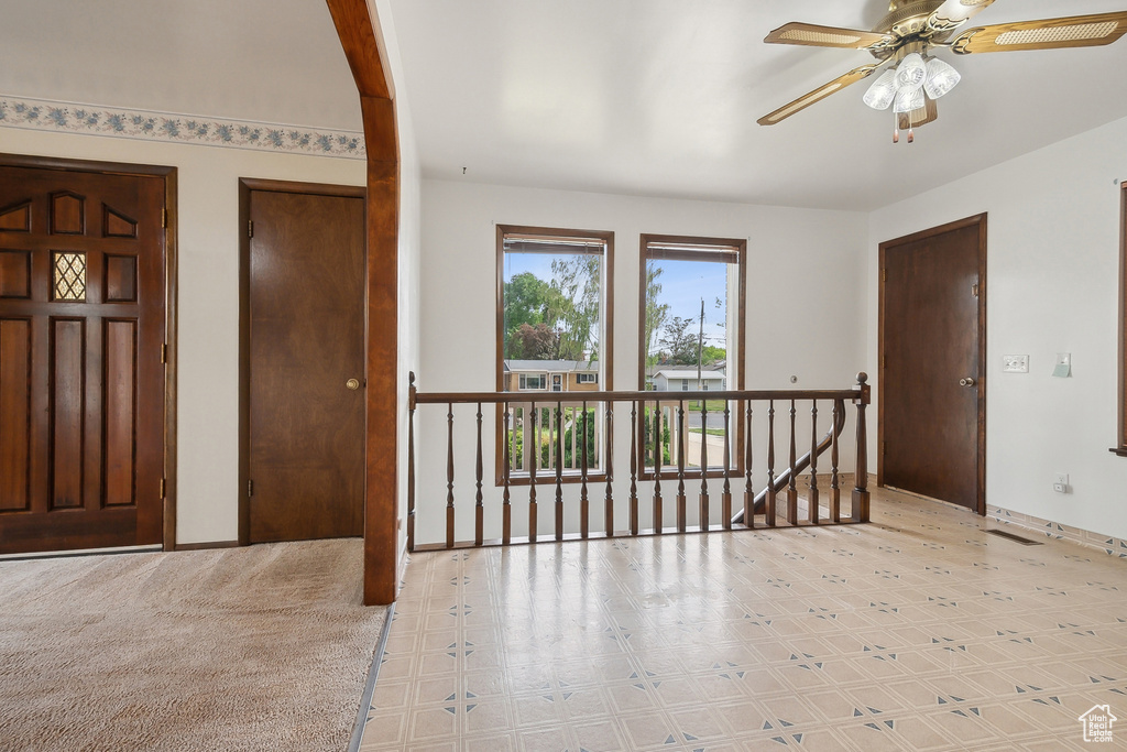 Entrance foyer featuring a ceiling fan, tile patterned floors, and baseboards