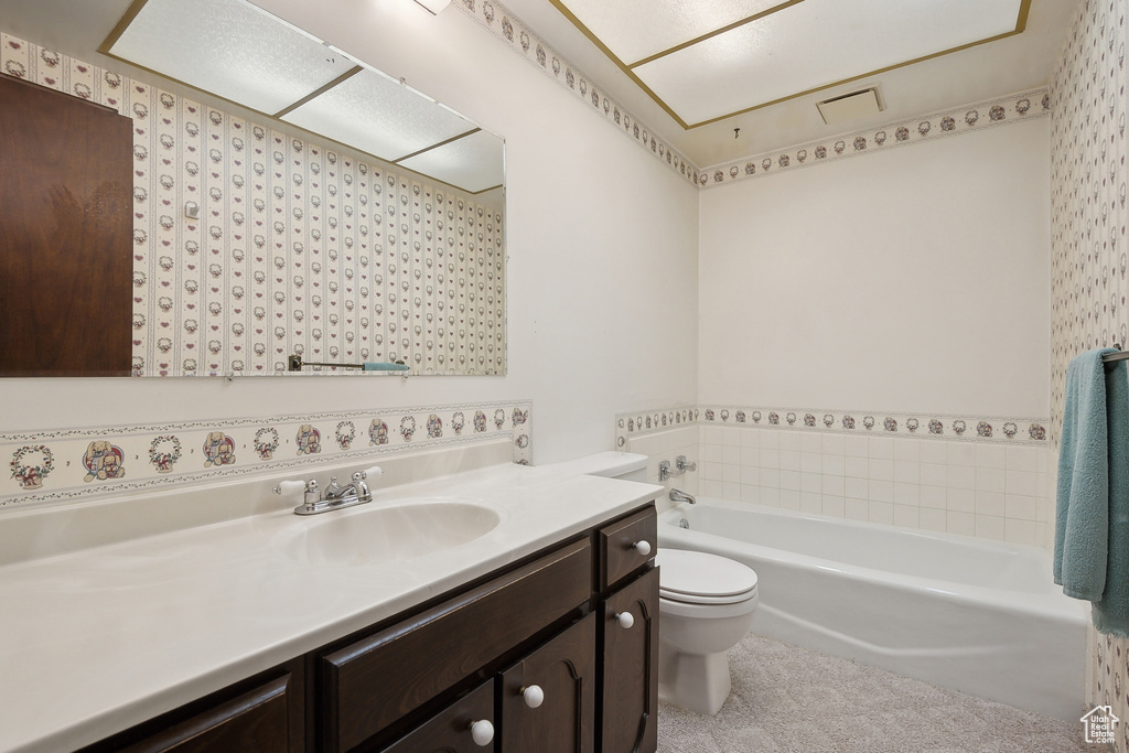 Full bath with a garden tub, vanity, and toilet