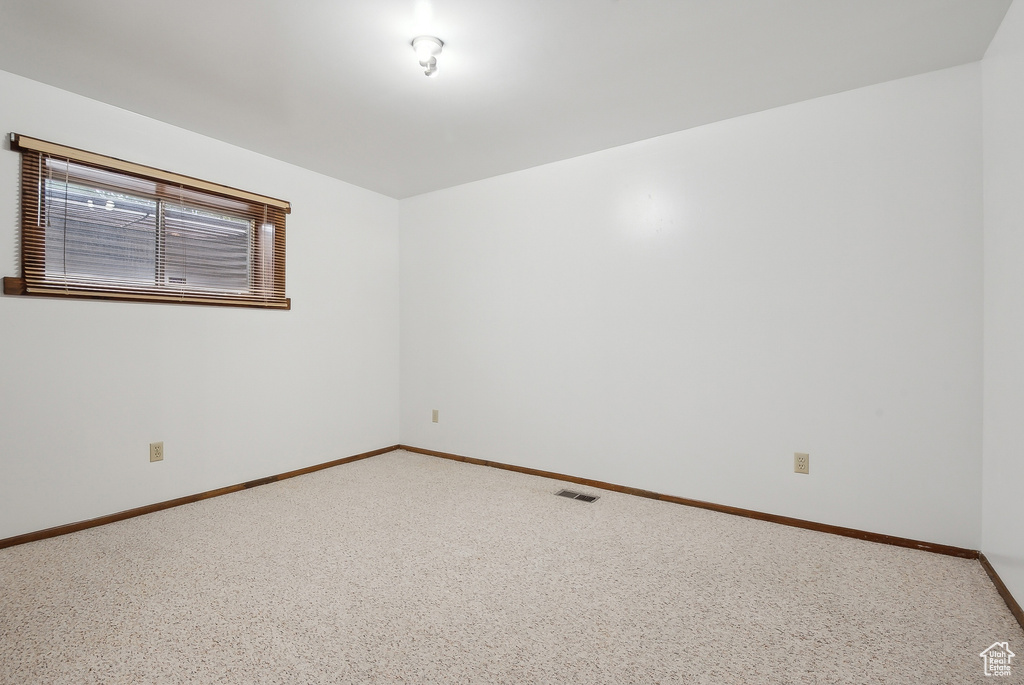 Unfurnished room featuring baseboards and carpet floors