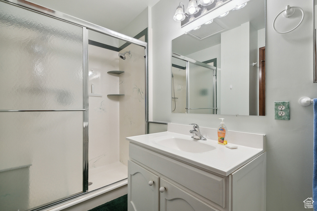 Bathroom featuring a shower stall and vanity