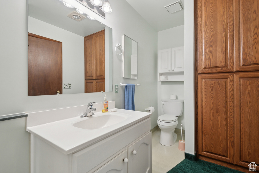 Bathroom featuring vanity and toilet