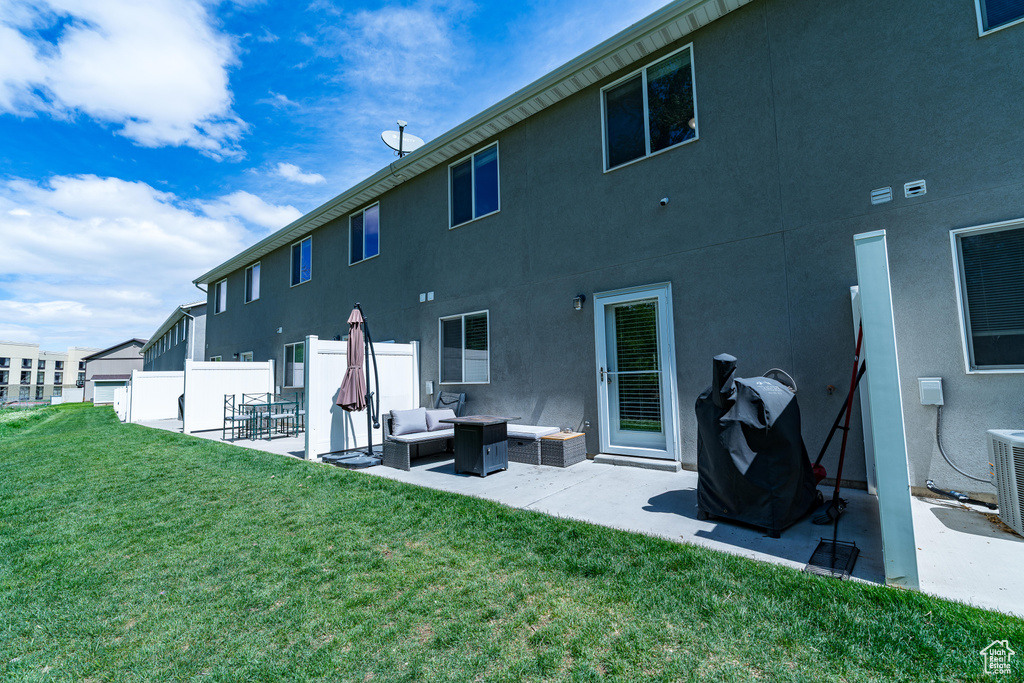 Back of property featuring a patio area, outdoor lounge area, stucco siding, and central AC