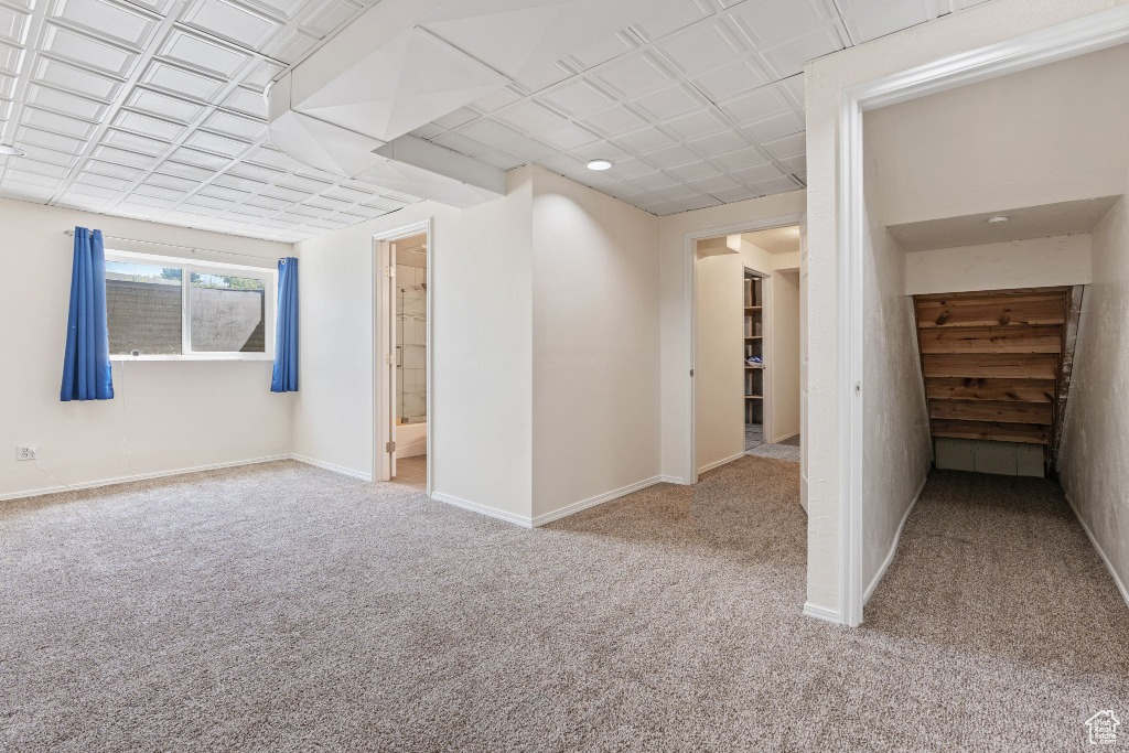 Carpeted spare room with baseboards