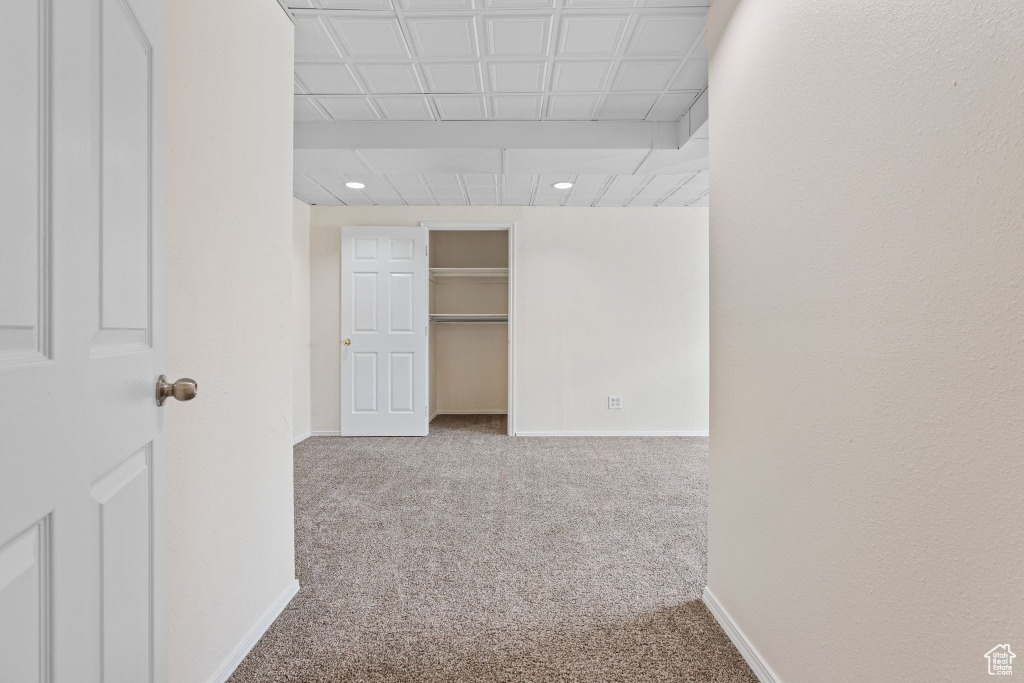 Hallway with carpet flooring, baseboards, and recessed lighting
