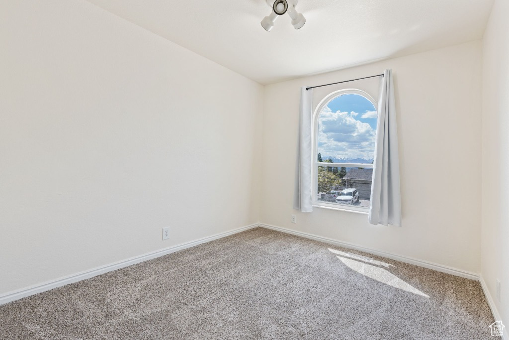 Spare room with carpet floors and baseboards