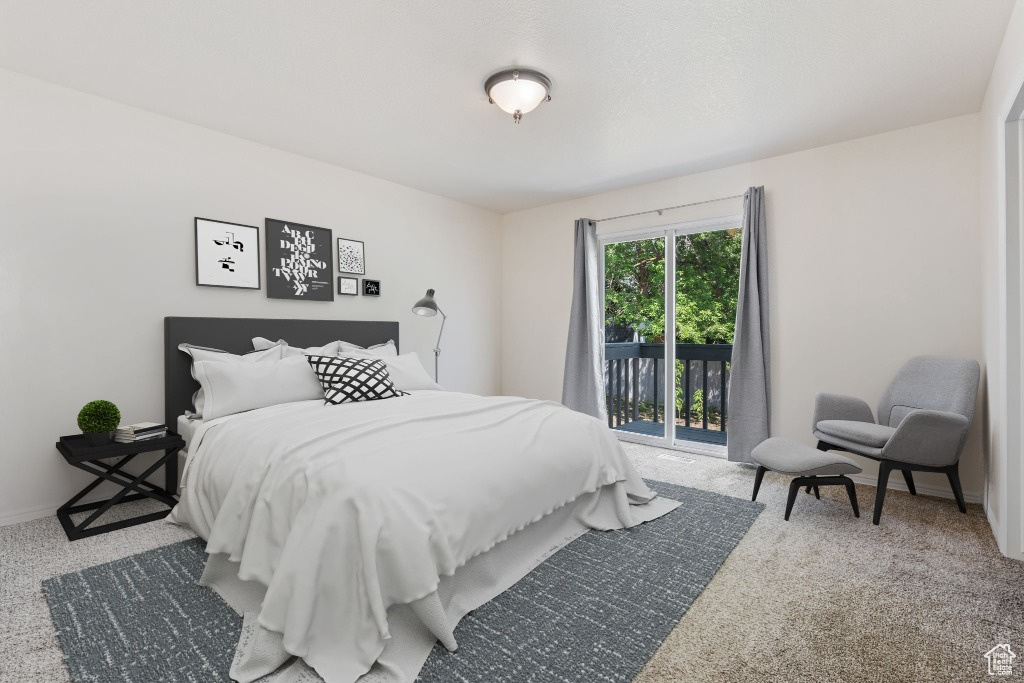 Bedroom with access to exterior, carpet, and baseboards