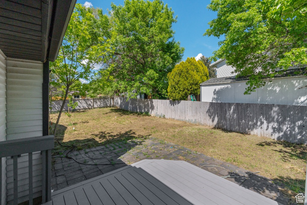 Deck featuring a fenced backyard and a patio area