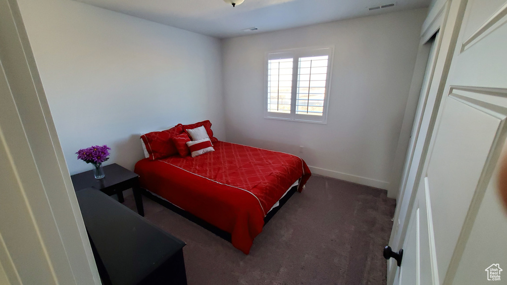 Bedroom featuring carpet flooring and baseboards