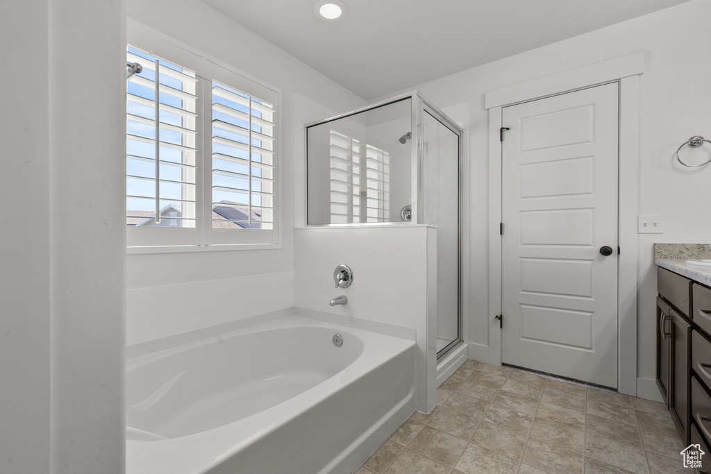 Full bath featuring a garden tub, a stall shower, vanity, and recessed lighting
