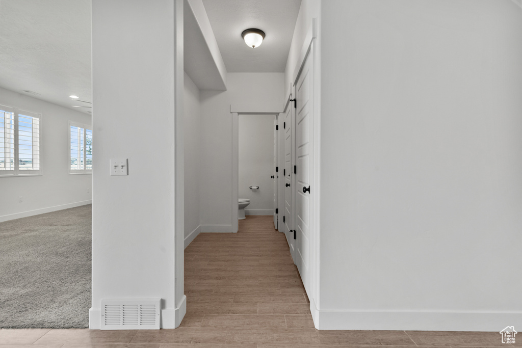 Hall featuring baseboards and light wood-type flooring