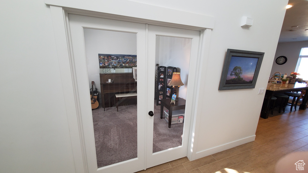 Hall with baseboards, recessed lighting, and wood finished floors