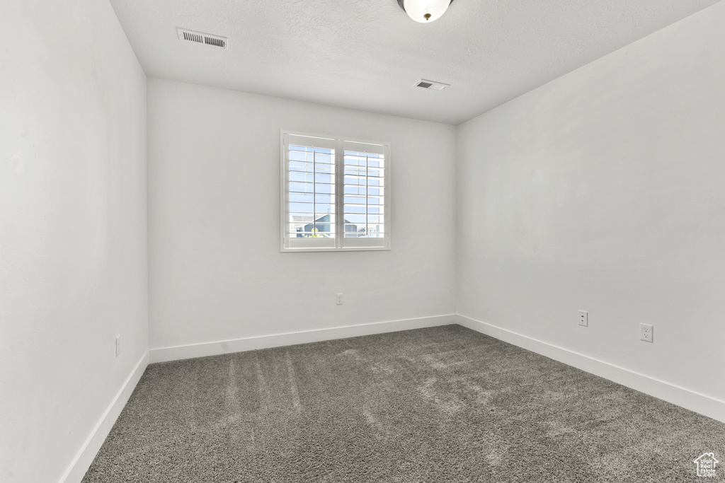 Unfurnished room featuring carpet floors and baseboards