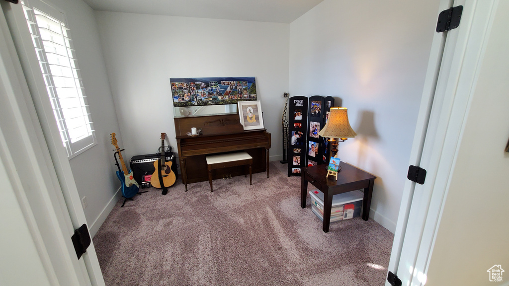 Sitting room with carpet and baseboards