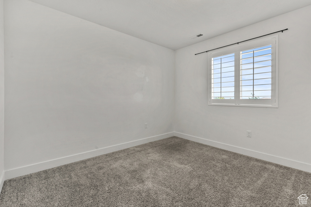 Unfurnished room with baseboards and carpet