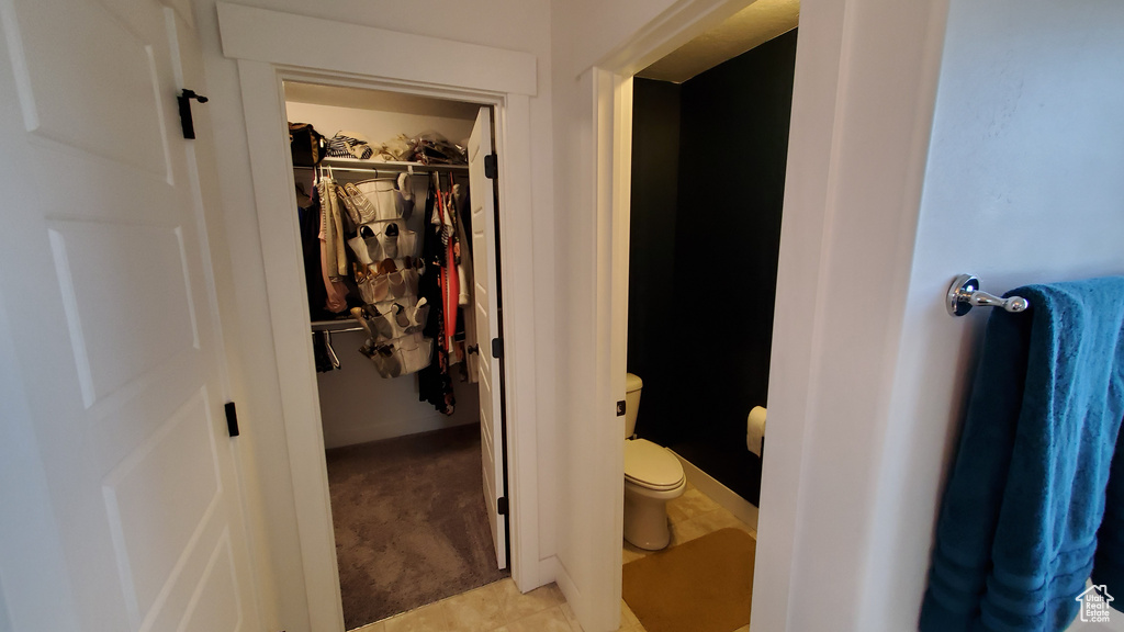 Bathroom with toilet and a spacious closet