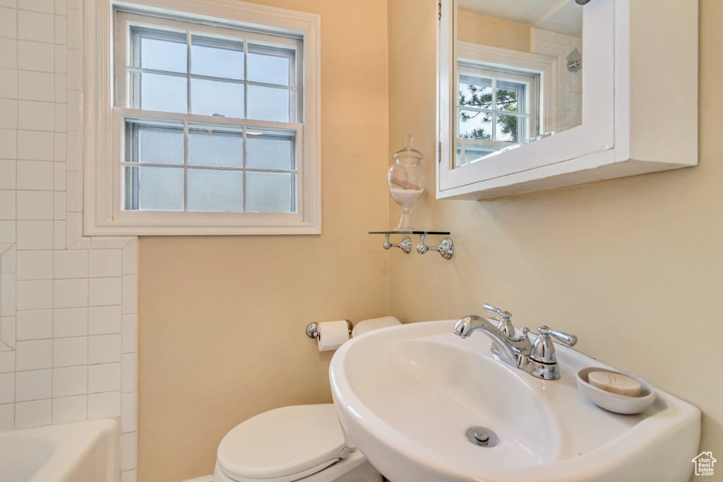 Full bath with a sink, toilet, and bathtub / shower combination