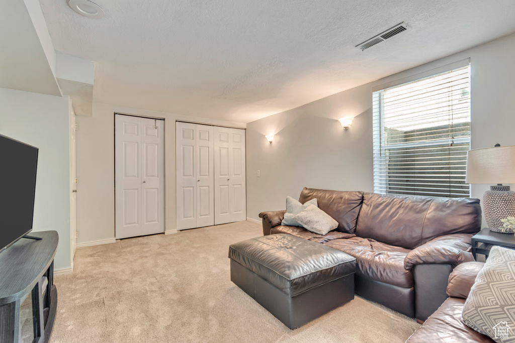 Living area with light carpet and baseboards