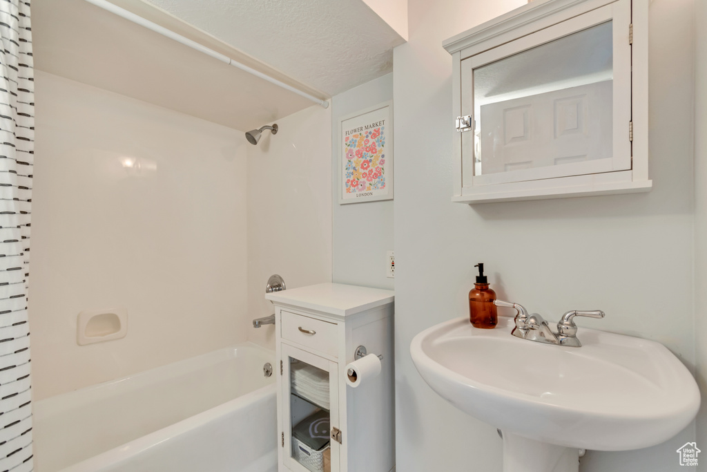 Full bathroom featuring shower / washtub combination and a sink